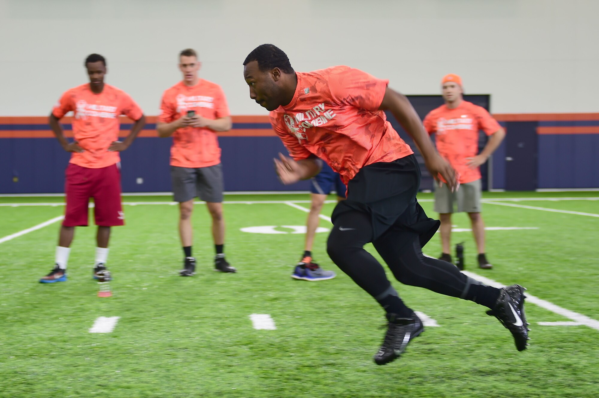 Senior Airman James Lampley, 460th Force Support Squadron career development technician, accelerates at the start of the shuttle drill portion on the military combine hosted by the Denver Broncos and United Services Automotive Association Aug. 7, 2015, at Denver Broncos Headquarters Facility at Dove Valley in Denver. The combine consisted of drills similar to the ones prospective National Football League players are expected to complete during the NFL combine held in Indianapolis before the NFL draft. All participants were also treated to a viewing of the Broncos’ Friday morning practice and a visit from Broncos players, as well as the head coach. (U.S. Air Force photo by Airman 1st Class Luke W. Nowakowski/Released)
