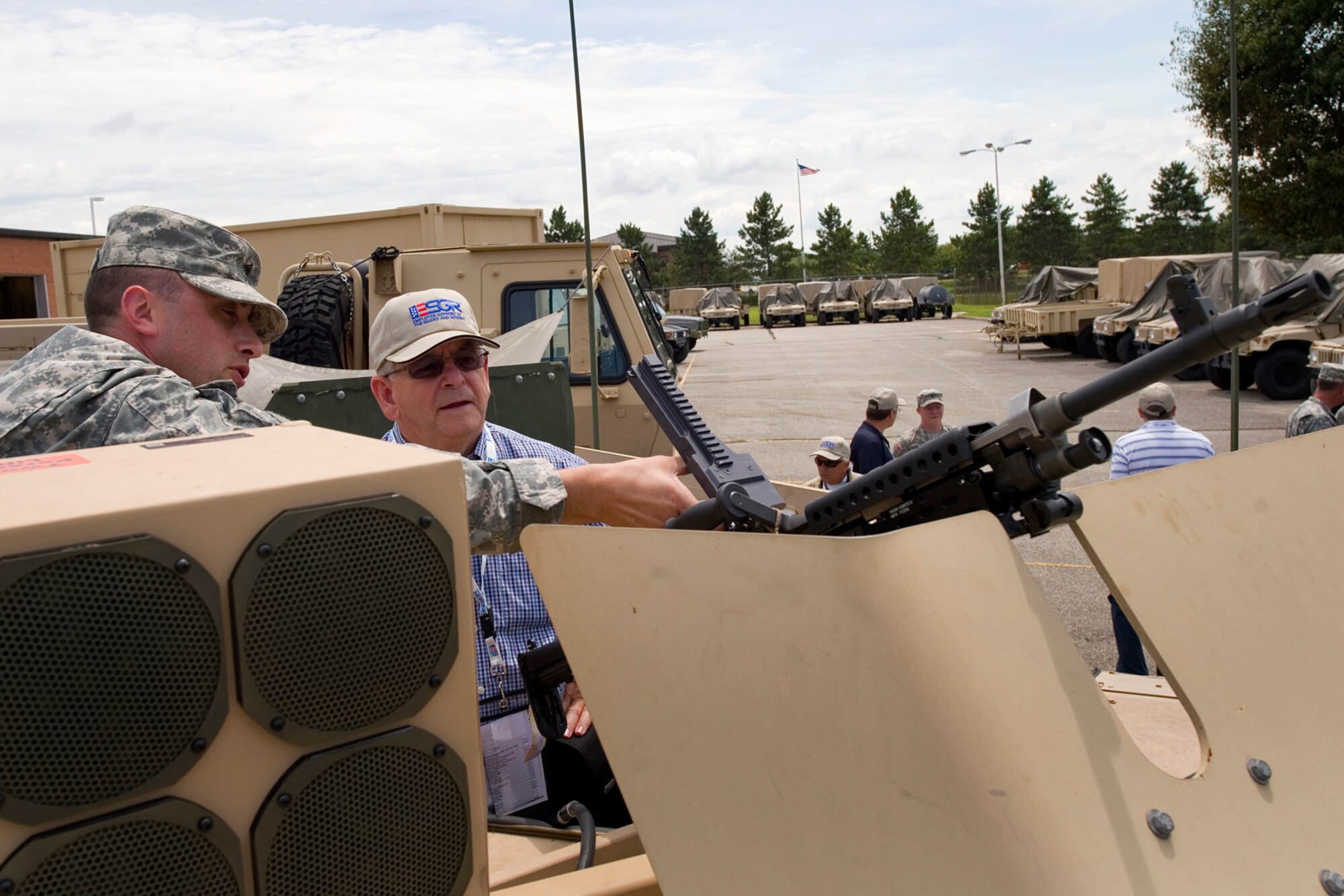 Army Reserve First Sgt. Nicholas Moore, 316th Psychological Operations Company first sergeant, explains the operating procedures of an M240B machine gun to Hal Job, 434th Air Refueling Wing honorary commander, during an ESGR tour for employers at Grissom Air Reserve Base, Ind., Aug. 6, 2015. During the two-day event , Airmen from the 434th ARW teamed up with those from the 122nd Fighter Wing in Fort Wayne, Ind., the 181st intelligence Wing in Terre Haute, Ind., and the Indiana Employer Support of the Guard and Reserve to host a tour and orientation flight. (U.S. Air Force photo/Tech. Sgt. Benjamin Mota)