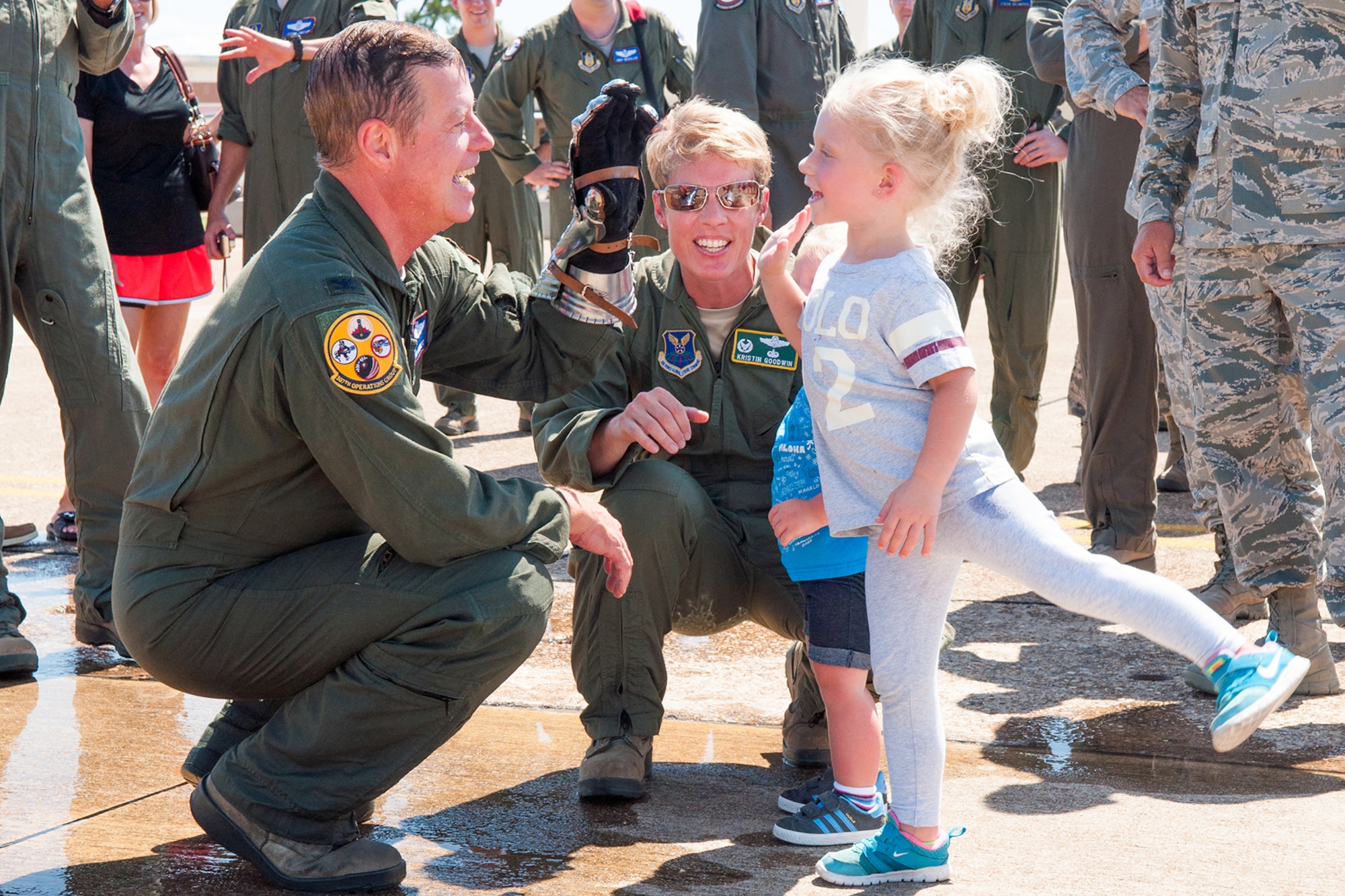 U.S. Air Force Col. Keith Schultz, commander of the 307th Operations Group, high-fives the daughter of the 2nd Bomb Wing Commander, Col. Kristin Goodwin, on Barksdale Air Force Base, La. on Aug. 2, 2015. Schultz had just landed from his final flight on a B-52H Stratofortress after spending the last 14 years at Barksdale. (U.S. Air Force photo by Master Sgt. Dachelle Melville/Released)