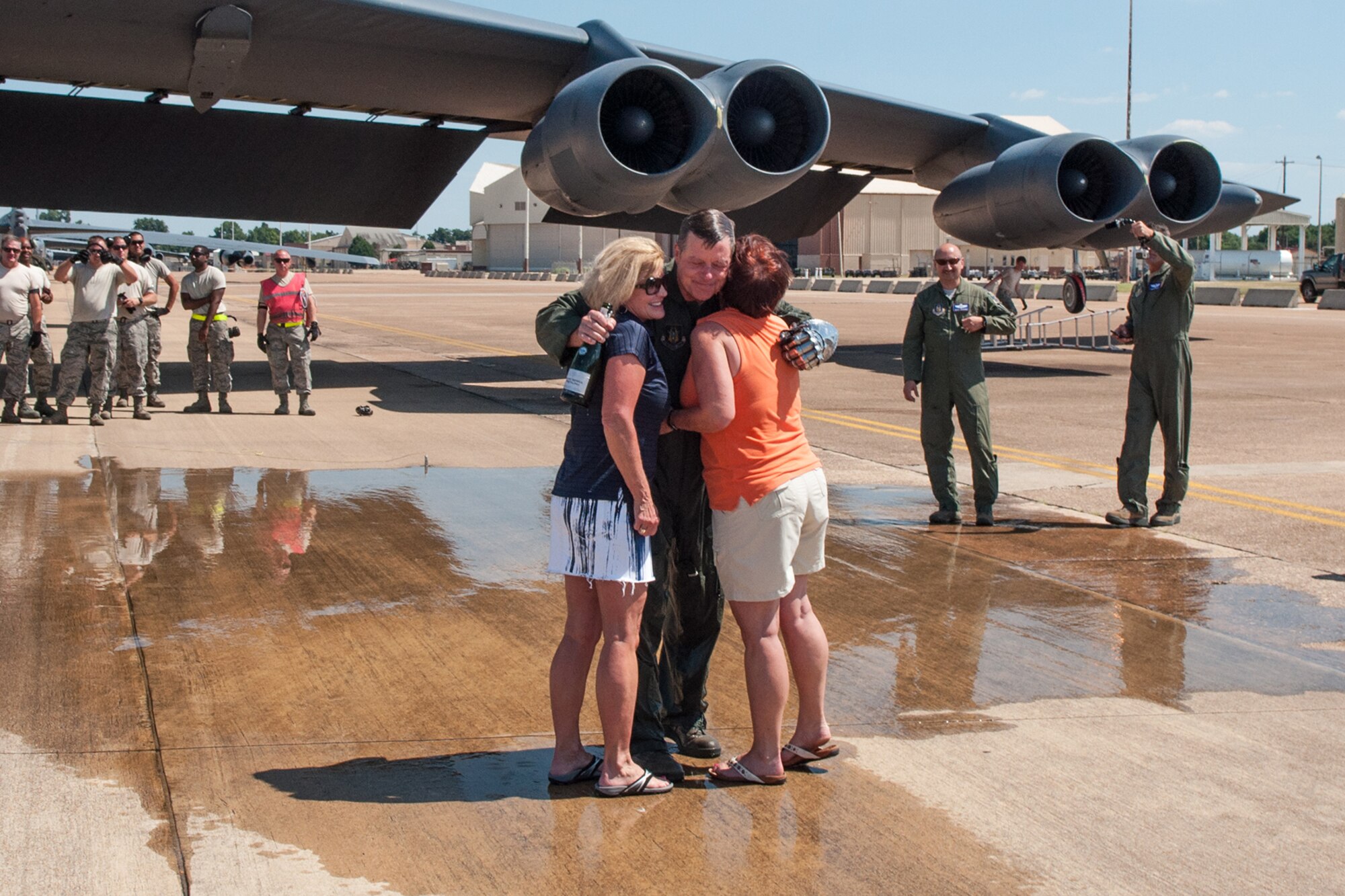U.S. Air Force Col. Keith Schultz, commander of the 307th Operations Group, hugs his sisters after landing from his final flight on a B-52H Stratofortress out of Barksdale Air Force Base, La. on Aug. 2, 2015. Schultz is a command pilot with over 7,000 flying hours. (U.S. Air Force photo by Master Sgt. Dachelle Melville/Released)