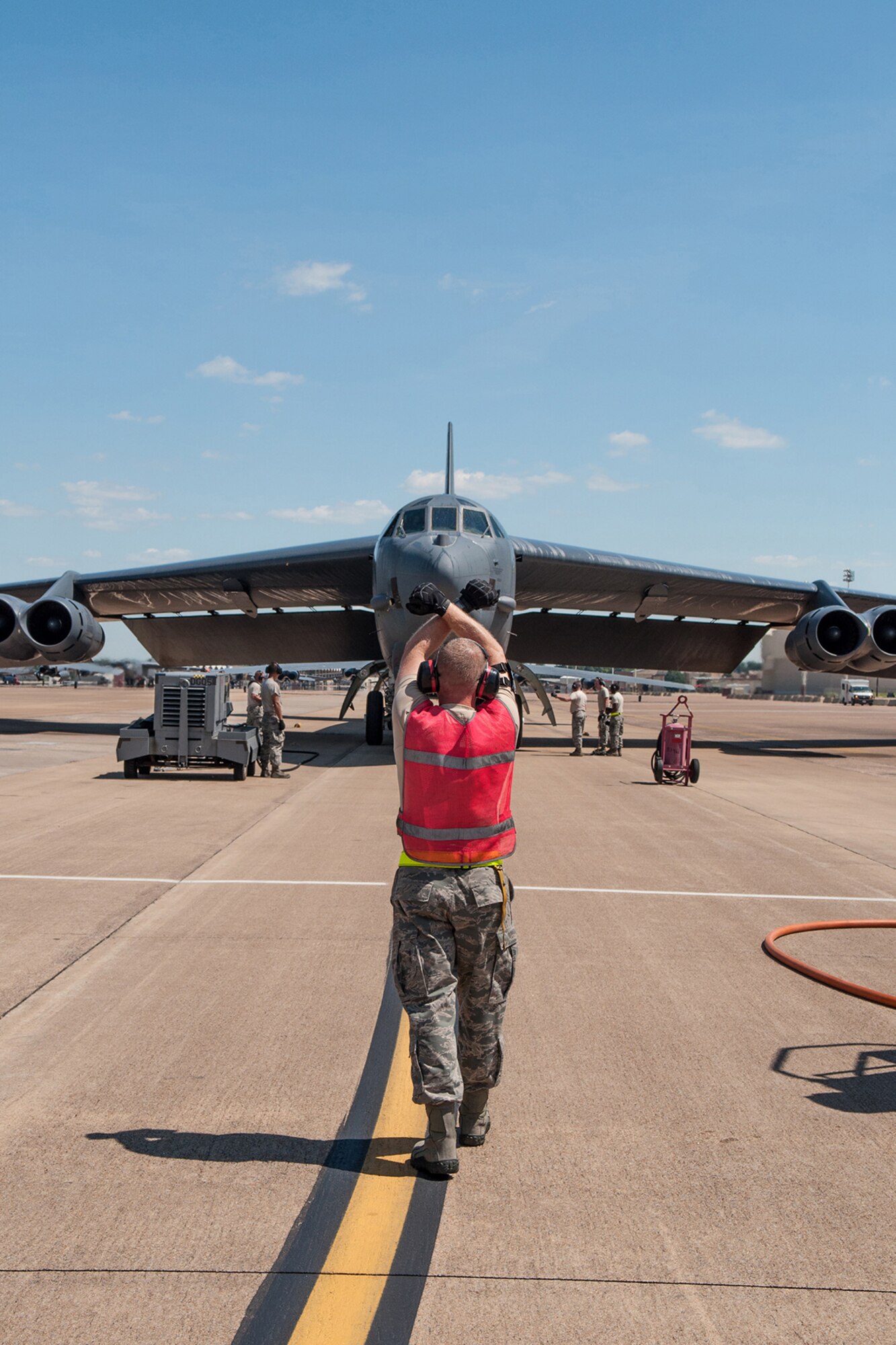 U.S. Air Force Airmen marshal in a B-52H Stratofortress piloted for the last time by Col. Keith Schultz, commander of the 307th Operations Group, on Barksdale Air Force Base, La. on Aug. 2, 2015. Schultz is a command pilot with over 7,000 flying hours and will be leaving Barksdale after 14 years. (U.S. Air Force photo by Master Sgt. Dachelle Melville/Released)