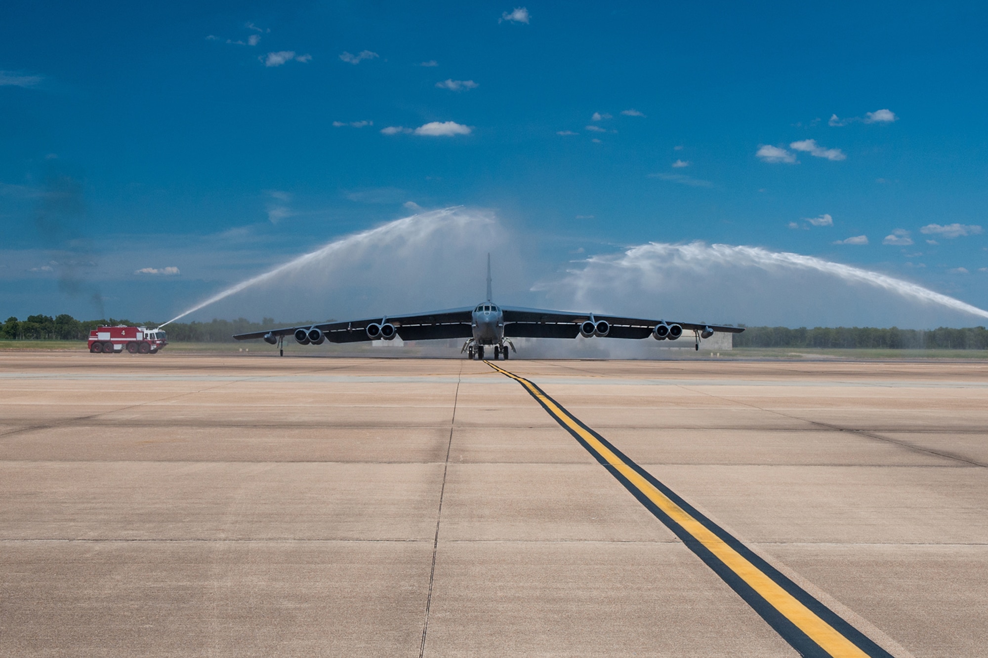 A B-52H Stratofortress taxis in under the spray of two fire trucks on Barksdale Air Force Base Aug. 2, 2015. The bomber’s pilot, U.S. Air Force Keith Schultz, commander of the 307th Operations Group, is returning from his final flight on the B-52 with more than 7,000 flight hours. (U.S. Air Force photo by Master Sgt. Dachelle Melville/Released)