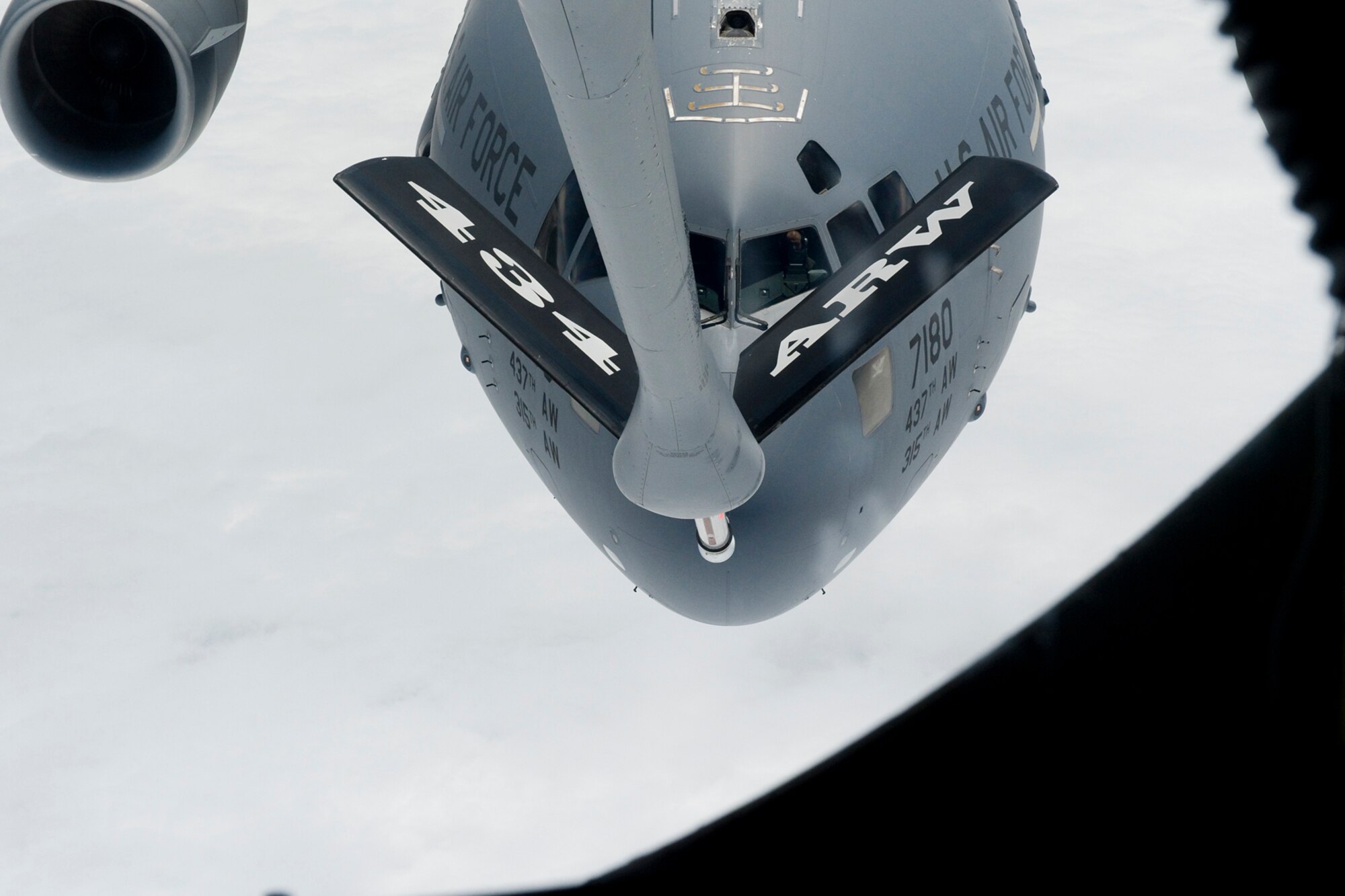 A C-17 Globemaster approaches the boom of a KC-135R Stratotanker to receive fuel during an Indiana Employer Support Guard and Reserve event held here Aug. 7, 2015. Employers were nominated by guard and reserve members from the 434th Air Refueling Wing in Grissom Ind., the 122nd Fighter Wing in Fort Wayne, Ind., the 181st Intelligence Wing in Terre Haute, Ind., and the Indiana ESGR to participate in a two-day tour and orientation flight. (U.S. Air Force photo/Senior Airman Jami K. Lancette)
