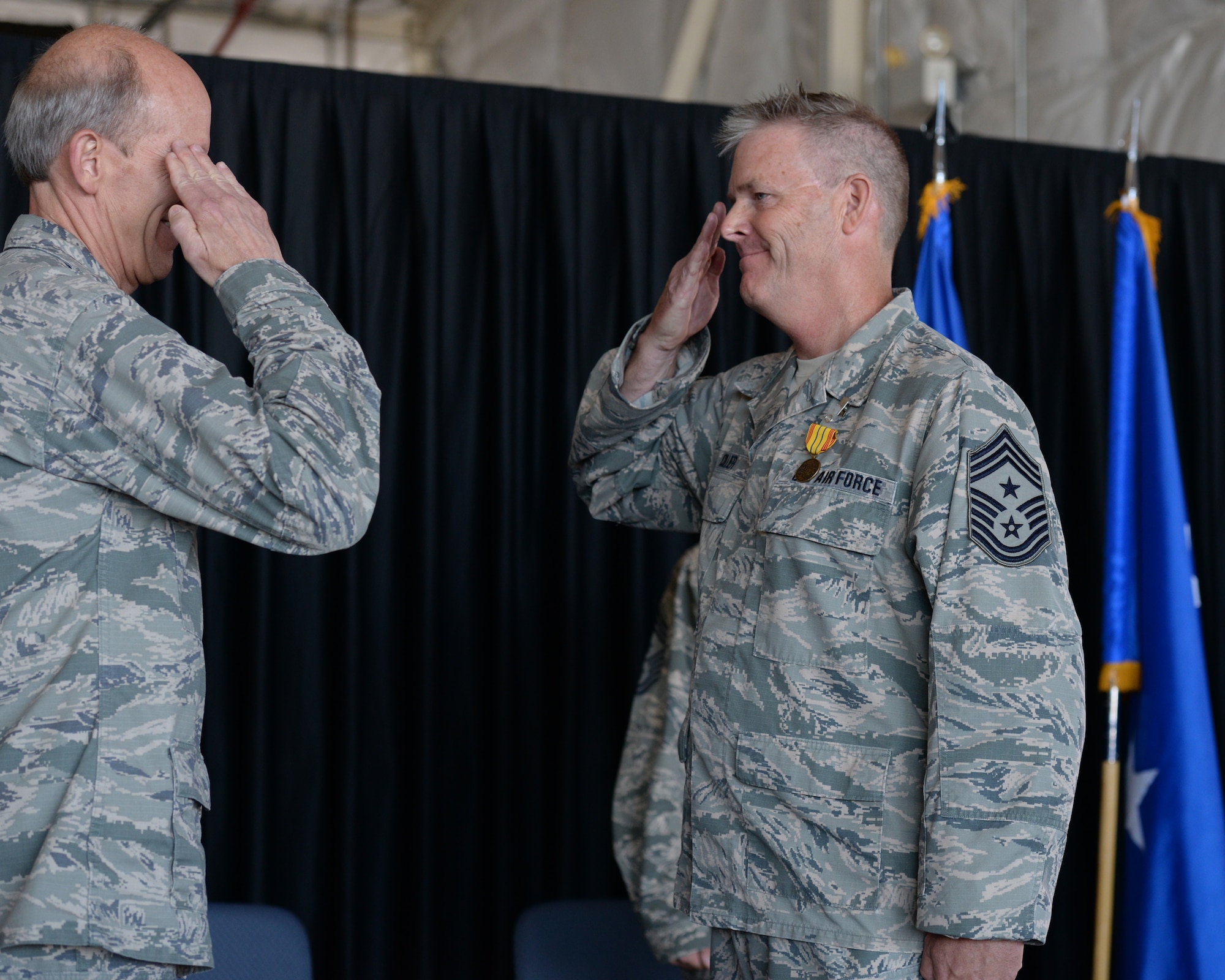 Outgoing New Hampshire Air National Guard State Command Chief Master Sgt. Matthew Collier salutes Maj. Gen. William N. Reddel III, N.H. National Guard adjutant general, during a change of authority ceremony at Pease Air National Guard Base, N.H., Aug. 9, 2015.  During the ceremony Collier relinquished authority to N.H. Command Chief Master Sgt. David Obertanec. (U.S. Air National Guard photo by Staff Sgt. Curtis J. Lenz)
