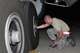 Senior Airman Sam Schwellenbach, hydraulics mechanic, checks the pressure of a MAFFS-equipped C-130 rear tire after it returned from a day of flying sorties on the River Complex fires in Northern California Aug. 5, 2015. As soon as the aircraft are done flying for the day the maintainers go to work to ensure it is ready for action the next day. (U.S. Air Force photo/Master Sgt. Daniel Butterfield)