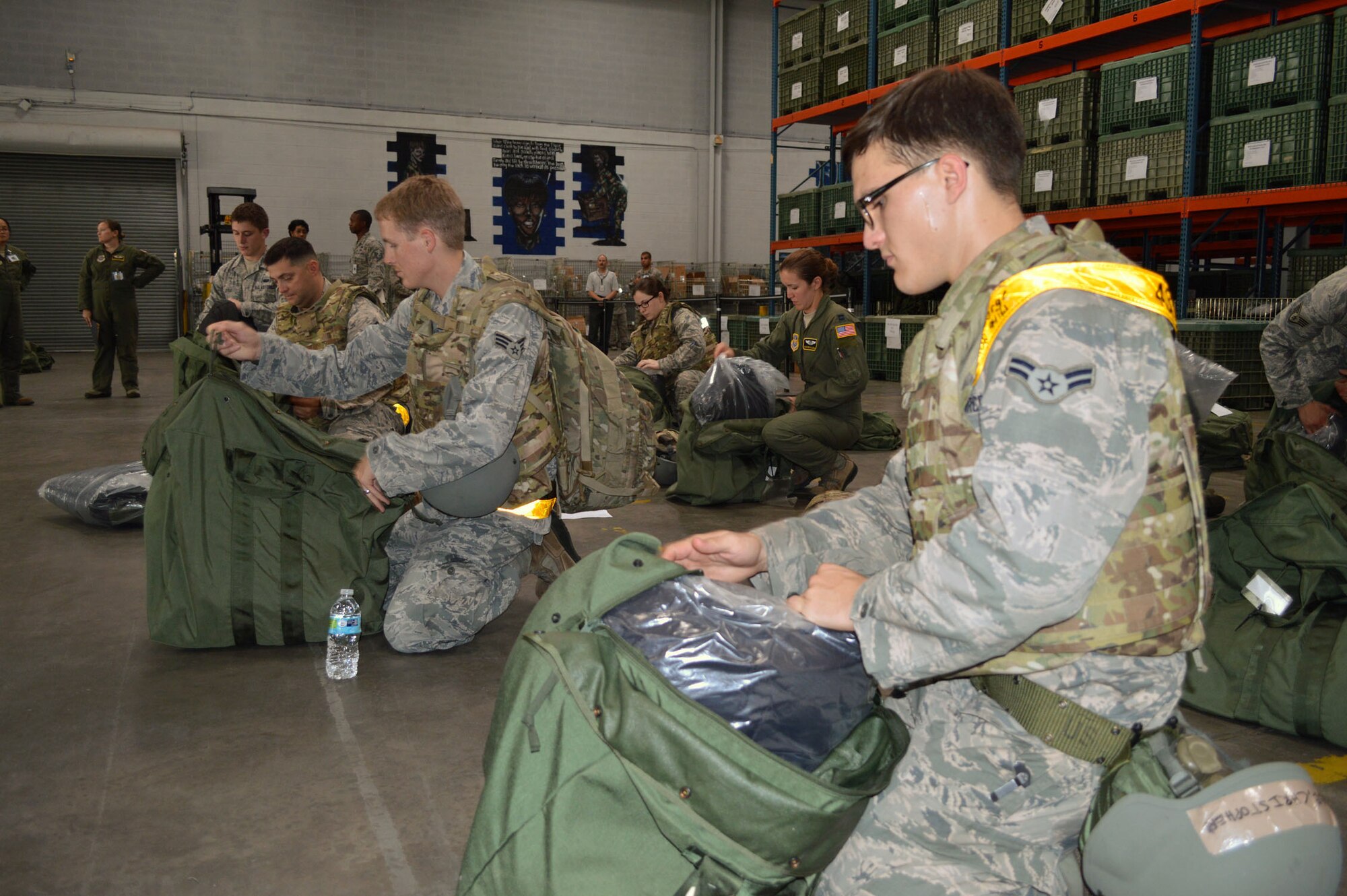 Airmen from the 43rd Airlift Group conduct an inventory of their deployment bags while processing through the personnel deployment function line during an operational readiness exercise Aug. 4 at Pope Army Airfield, North Carolina. (U.S. Air Force photo/Marvin Krause)