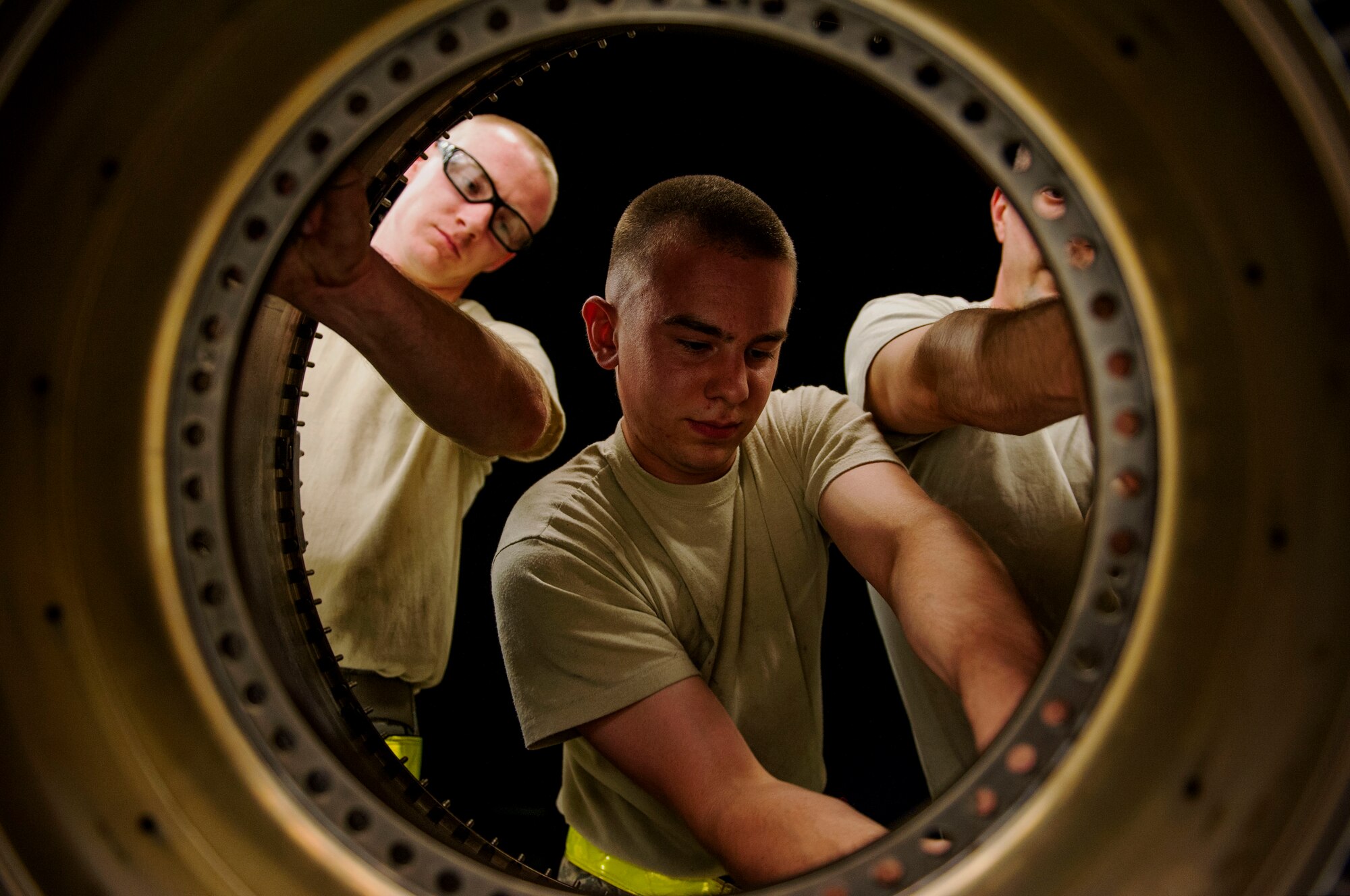 Maintainers from the 35th Maintenance Group, Misawa Air Base, Japan, work on a jet engine component during a graveyard shift on Spangdahlem Air Base, Germany, August 5, 2015. The shop divides Airmen into different sections with each working on a different part and function of the component’s work orders. The graveyard shift, also referred to as a swing shift, is a period of time when Airmen work from nighttime through early morning hours. (U.S. Air Force photo by Airman 1st Class Timothy Kim/Released)