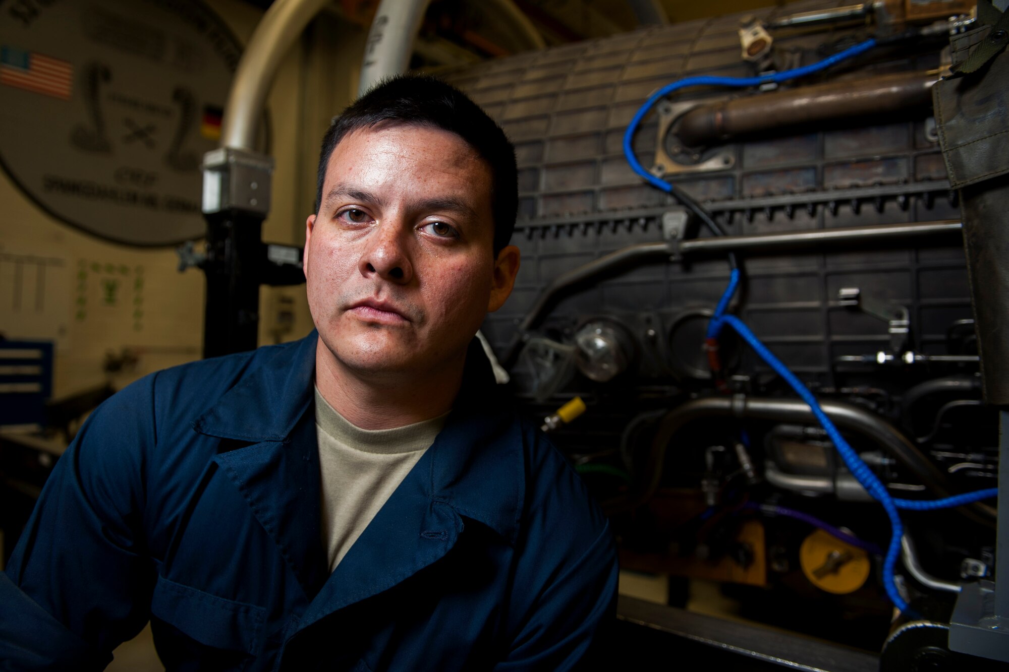 U.S. Air Force Staff Sgt. Jacob Pope, 52nd Component Maintenance Squadron aerospace propulsion craftsman, poses for a photo during a graveyard shift on Spangdahlem Air Base, Germany, August 5, 2015. The 52nd CMS works on jet engine components in need of repair as well as provided scheduled maintenance. The graveyard shift, also referred to as a swing shift, is a period of time when Airmen work from nighttime through early morning hours. (U.S. Air Force photo by Airman 1st Class Timothy Kim/Released)
