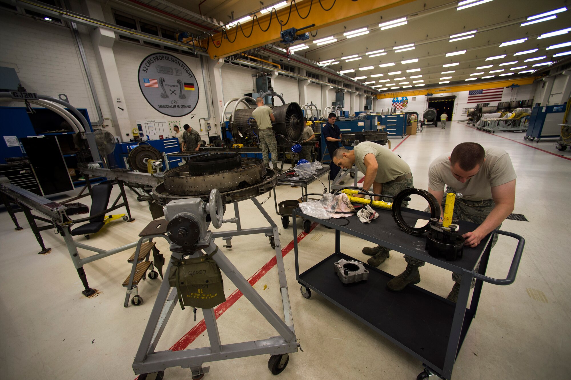 Members of the 52nd Component Maintenance Squadron work in their shop during a graveyard shift on Spangdahlem Air Base, Germany, August 5, 2015. Squadrons utilize the graveyard shift to continue work production after regular work hours. The graveyard shift, also referred to as a swing shift, is a period of time when Airmen work from nighttime through early morning hours. (U.S. Air Force photo by Airman 1st Class Timothy Kim/Released)