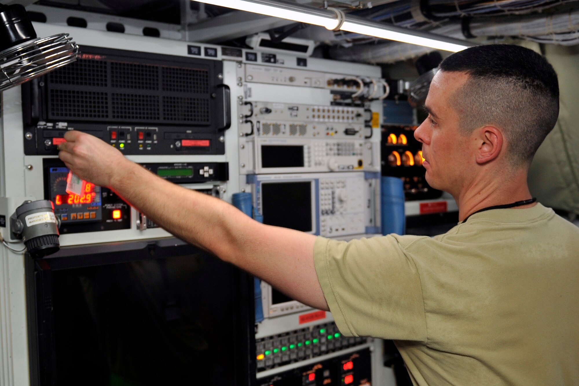 U.S. Air Force Airman 1st Class Nathan Dunster, 55th Intelligence Support Squadron electronic warfare systems apprentice, follows the “power on” checklist for the reconnaissance equipment on the RC-135 Rivet Joint Aug. 6 at Offutt Air Force Base, Nebraska. He recently earned a 95 percent on his career development course end of course exam, the highest score ever recorded in his career field. (U.S. Air Force photo by Jeff W. Gates/Released)

