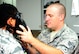 Senior Airman Kevin Morgan, 14th Medical Operations Squadron Bioenvironmental Technician, gives an Airman a gas mask fit check Aug. 5 at Columbus Air Force Base, Mississippi. A fit check should be performed each time a tight-fitting respirator is donned to ensure the seal is adequate. (U.S. Air Force photo/Senior Airman Kaleb Snay)