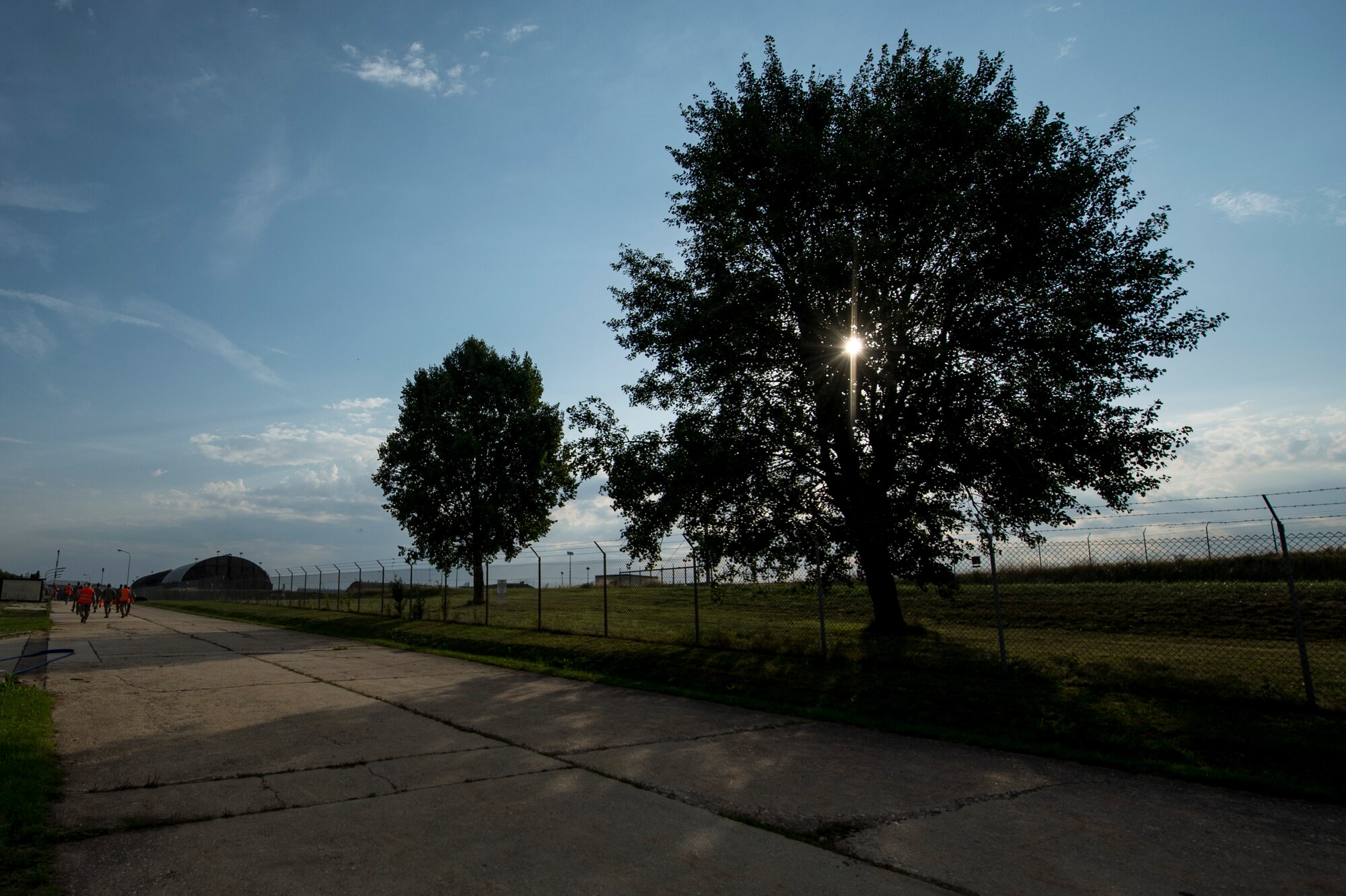 Members of the exercise evaluation team walk away from an exercise scene, prior to the start of a fuel spill exercise Aug. 7, 2015, at Spangdahlem Air Base, Germany. The exercise verified the first responder’s skills to respond to a large-scale fuel spill. (U.S. Air Force photo by Senior Airman Rusty Frank/Released)