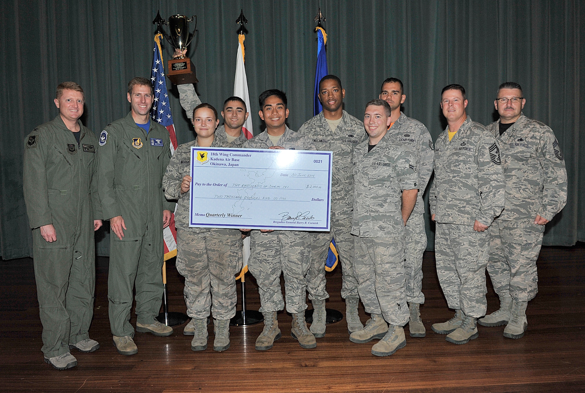 U.S. Air Force Dorm 141 council members are presented the Dorm of the Quarter Award during Team Kadena's second-quarter awards ceremony at the Keystone Theater on Kadena Air Base, Japan, Aug. 7, 2015. For quality of life improvements to the dormitories, Dorm 141 was given a $2,000 prize for winning first place during the second quarter. (U.S. Air Force photo by Naoto Anazawa/Released)