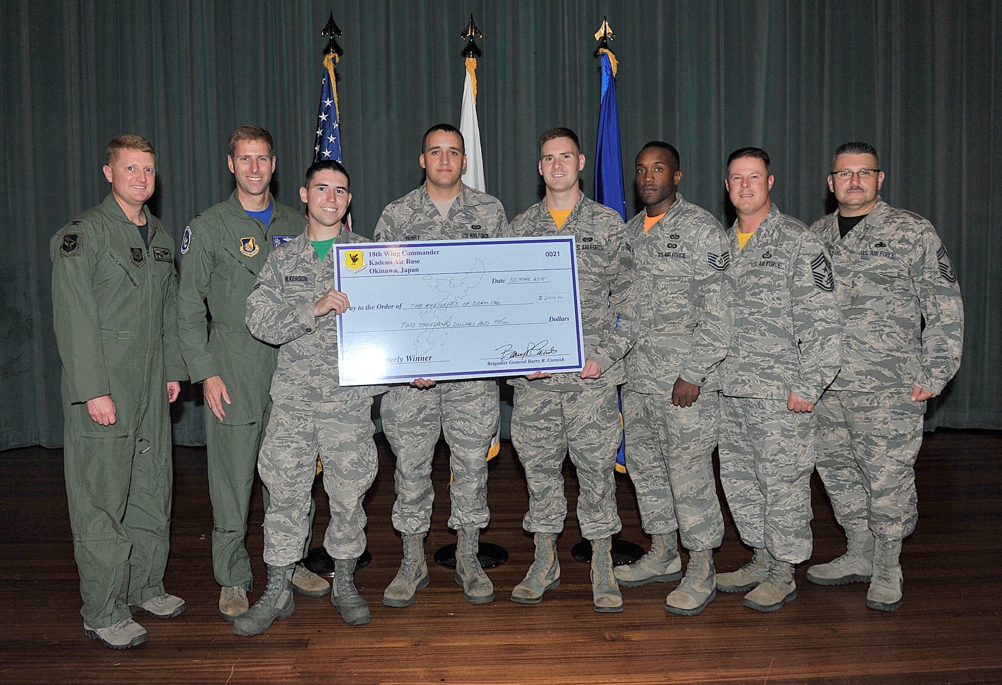 U.S. Air Force Dorm 176 council members are presented the Dorm of the Quarter Award during Team Kadena's second-quarter awards ceremony at the Keystone Theater on Kadena Air Base, Japan, Aug. 7, 2015. For quality of life improvements to the dormitories, Dorm 176 was given a $2,000 prize for winning first place during the first quarter. (U.S. Air Force photo by Naoto Anazawa/Released)