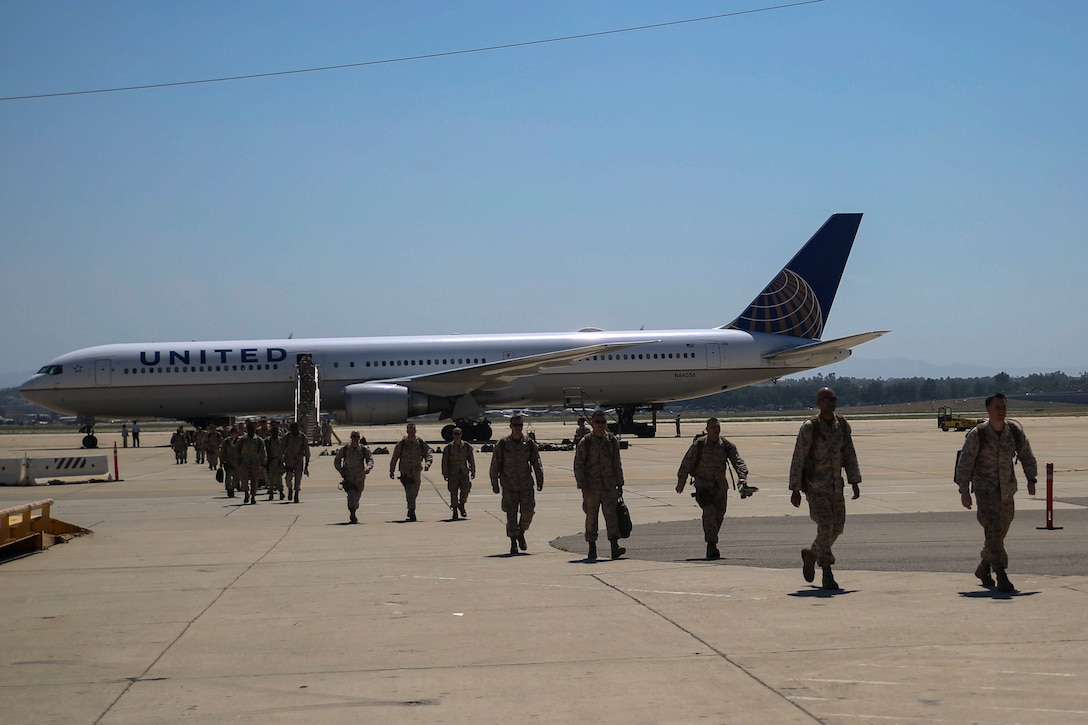 Marines with 2d Marine Expeditionary Brigade arrive at March Air Force Reserve Base, Calif. in support of the 2d MEB Large Scale Exercise Aug. 7, 2015. LSE is a combined U.S. Marine Corps, Canadian and British exercise conducted at the Brigade-level, designed to enable live, virtual and constructive training for participating forces. (U.S. Marine Corps photo by Cpl. Tyler A. Andersen/Released)