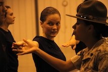 Sergeant Rosario Battiest, a Company N, 4th Recruit Training Battalion, Marine Corps Recruit Depot Parris Island drill instructor,corrects a poolees drill deficiency during Marine Corps Recruiting Station Kansas City's all-hands female pool function at Camp Clark in Nevada, Mo., Aug. 7, 2015.