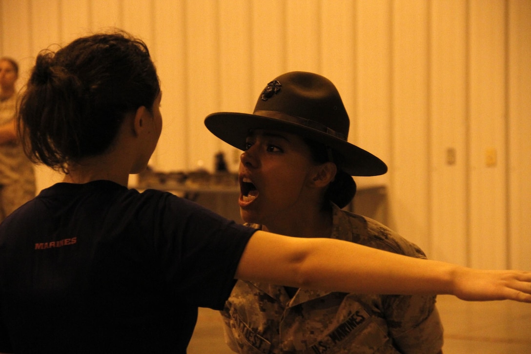 Sergeant Rosario Battiest, a Company N, 4th Recruit Training Battalion, Marine Corps Recruit Depot Parris Island drill instructor, instructs a poolee to speak more concisely during Marine Corps Recruiting Station Kansas City's all-hands female pool function at Camp Clark in Nevada, Mo., Aug. 7, 2015.