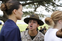 Sergeant Rosario Battiest, a Company N, 4th Recruit Training Battalion, Marine Corps Recruit Depot Parris Island drill instructor, tells a poolee to increase her volume during Marine Corps Recruiting Station Kansas City's all-hands female pool function at Camp Clark in Nevada, Mo., Aug. 7, 2015.