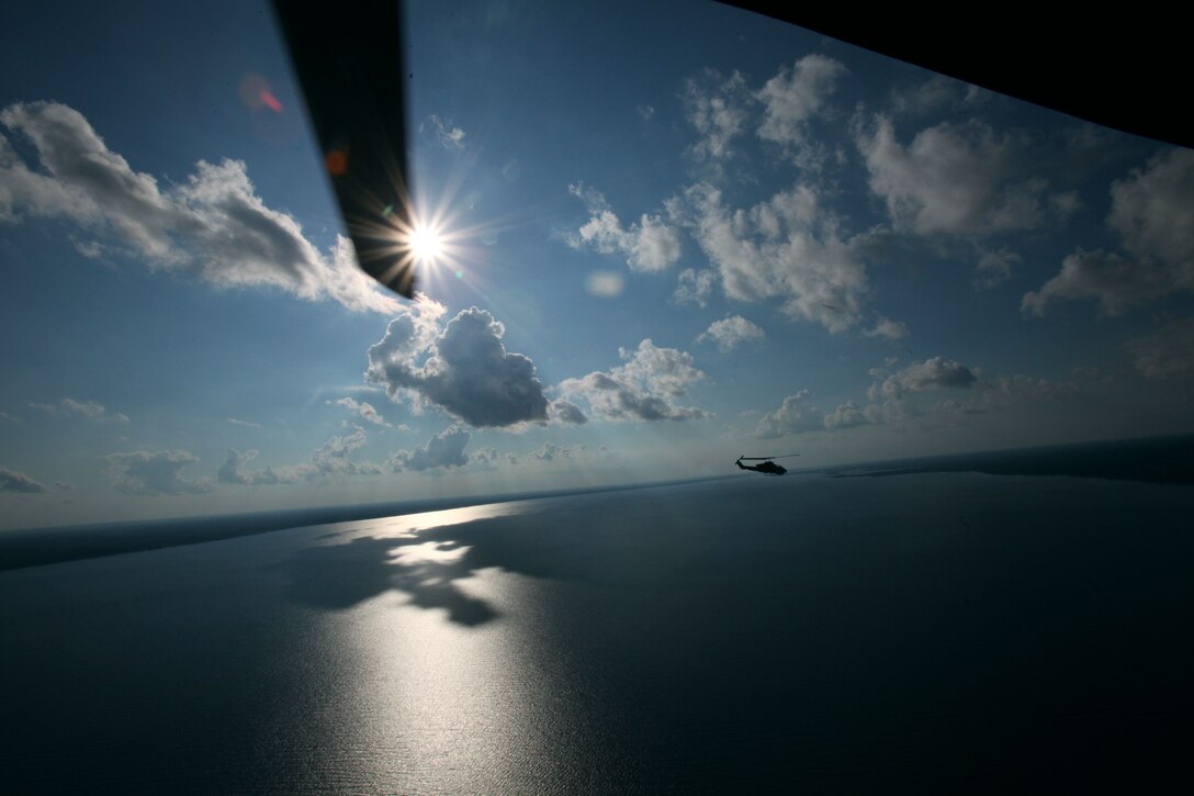 A UH-1Y Huey flies alongside an AH-1W Super Cobra during a training exercise testing a digital interoperability system at Marine Corps Air Station Cherry Point, North Carolina, July 24, 2015. Digital interoperability is the technology capable of increasing prowess on the battlefield.  The exercise included Marine Light Attack Helicopter Squadron 467, Marine Unmanned Aerial Vehicle Squadron 2, and U.S. Marine Corps Forces, Special Operations Command, testing a LINK 16 conversion system for one of the first times within an explicitly rotary-wing exercise. 