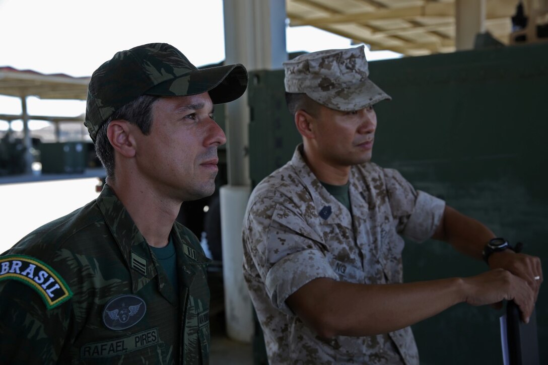 Master Sgt. Alex Ng, the field artillery chief assigned to Battery Q, 5th Battalion, 11th Marine Regiment, 1st Marine Division, explains the abilities of the M142 High-Mobility Artillery Rocket System to Maj. Rafael Pires Ferreira, a battery commander with Brazil’s Corpo de Fuzileios, aboard Marine Corps Base Camp Pendleton, Calif., Aug. 5, 2015. Two Brazilian military officers participated in a Subject Matter Expert Exchange with the Marines and Sailors of 11th Marines to compare standard operating procedures and to share experiences and ideas.