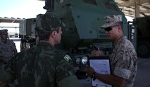 Master Sgt. Alex Ng, the field artillery chief assigned to Battery Q, 5th Battalion, 11th Marine Regiment, 1st Marine Division, explains the abilities of the M142 High-Mobility Artillery Rocket System to Maj. Rafael Pires Ferreira, a battery commander with Brazil’s Corpo de Fuzileios, aboard Marine Corps Base Camp Pendleton, Calif., Aug. 5, 2015. Two Brazilian military officers participated in a Subject Matter Expert Exchange with the Marines and Sailors of 11th Marines to compare standard operating procedures and to share experiences and ideas.