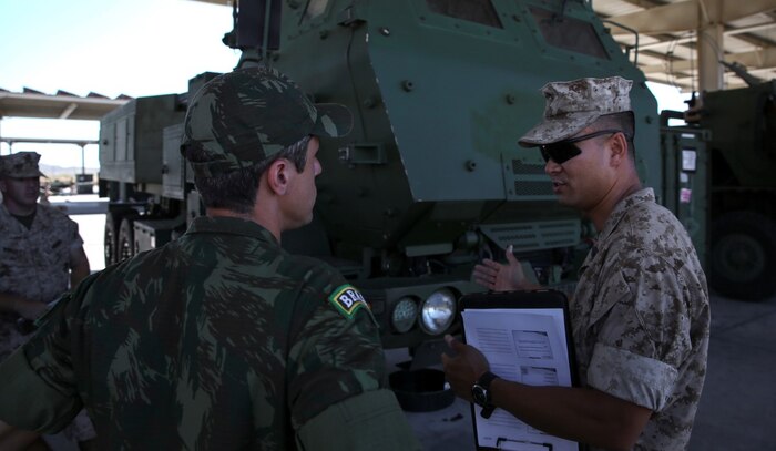 Master Sgt. Alex Ng, the field artillery chief assigned to Battery Q, 5th Battalion, 11th Marine Regiment, 1st Marine Division, explains the abilities of the M142 High-Mobility Artillery Rocket System to Maj. Rafael Pires Ferreira, a battery commander with Brazil’s Corpo de Fuzileios, aboard Marine Corps Base Camp Pendleton, Calif., Aug. 5, 2015. Two Brazilian military officers participated in a Subject Matter Expert Exchange with the Marines and Sailors of 11th Marines to compare standard operating procedures and to share experiences and ideas.