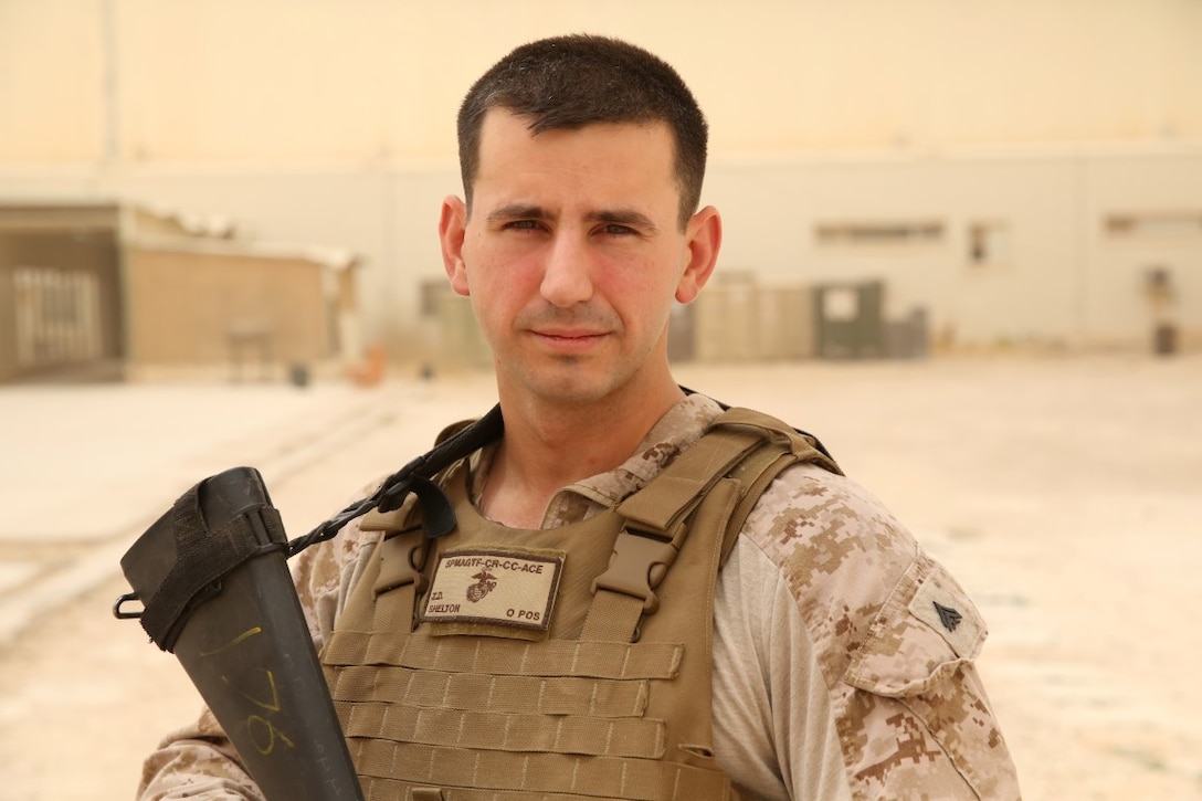 U.S. Marine Cpl. Zachary Shelton, an embarkation specialist with Special Purpose Marine Air-Ground Task Force—Crisis Response—Central Command, poses for a picture on Al Asad Air Base, Iraq, July 12, 2015. As an embarkation specialist, Shelton is responsible for manifesting and tracking weapons, equipment, and personnel that travel by air. The Marines and Sailors of SMPAGTF-CR-CC are deployed to several locations in the Middle East in support of Operation Inherent Resolve and contingency operations.