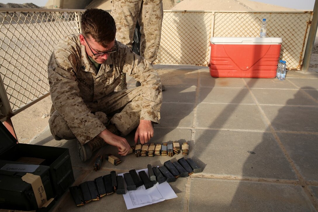 U.S. Marine Sgt. Corey Erickson with Special Purpose Marine Air-Ground Task Force - Crisis Response - Central Command, loads M9 pistol magazines during a competitive pistol range while deployed in Southwest Asia, July 20, 2015. The Marines and Sailors of SPMAGTF-CR-CC provide the commander of USCENTCOM a nimble set of task-organized solutions to emerging crises in an area of operations spanning 20 countries in the Middle East. (U.S. Marine Corps Photo by Cpl. Cansin P. Hardyegritag)