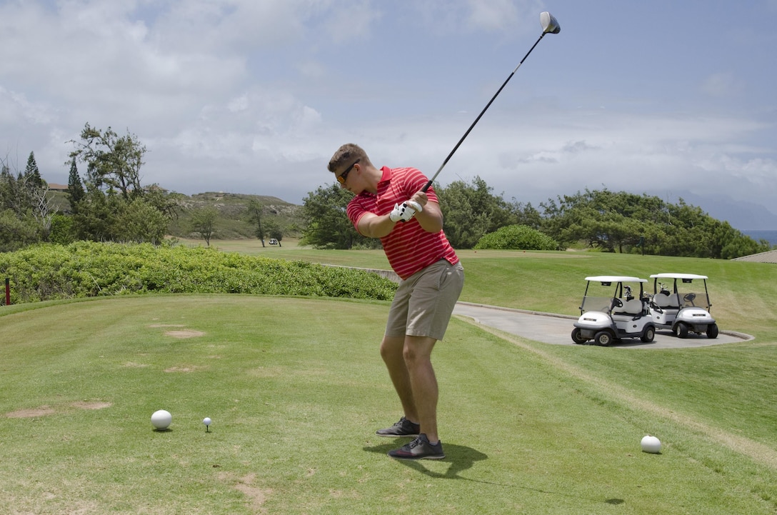 U.S. Marine Cpl. Jon Bostick, an avionics technician with Marine Aviation Logistics Squadron 24 and a Saginaw, Mich., native, prepares to drive his ball down the green during the Shank & Slice Golf Tournament at the Kaneohe Klipper Golf Course, Aug. 7, 2015. Coordinated by the Single Marine & Sailor Program, the four-man scramble competition was open to all hands, and Marine Corps Base Hawaii service members could earn points toward the 101 Days of Summer Program by participating. The tournament is one of the many activities provided by Marine Corps Community Services Hawaii, which ultimately supports the mission of MCCS, as well as the base, which is to provide facilities, programs and services for its units, individuals and families in order to enhance and sustain combat readiness for all operating forces and tenant organizations. (U.S. Marine Corps photo by Kristen Wong/Released)