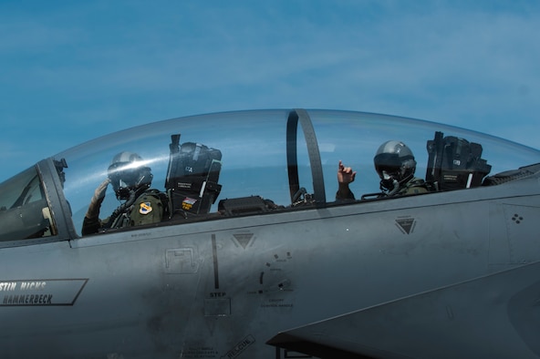 Lt. Col. Paul Hibbard, a 333rd Fighter Squadron instructor pilot, and Capt. Justin Thompson, a 333rd FS pilot, signal their crew chief as they taxi to the runway, July 22, 2015, at Seymour Johnson Air Force Base, N.C. After flying in operational squadrons for most of his career, Hibbard now instructs F-15E Strike Eagle aircrew on the intricacies of operating the aircraft. (U.S. Air Force photo/Airman Shawna L. Keyes)