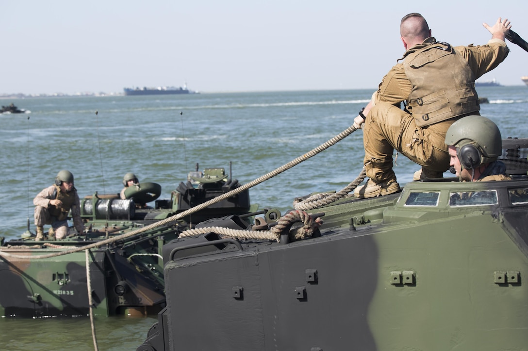 Marines with Company C, 4th Assault Amphibian Battalion, 4th Marine Division, Marine Forces Reserve, participate in a vehicle recovery exercise at the Galveston Marine Corps Reserve Home Training Center, Aug. 8, 2015. During the vehicle recovery exercise, Marines attached tow ropes to the defective amphibious assault vehicle and used another vehicle to bring it back to land. (U.S Marine Corps photo by Corporal Ian Ferro)