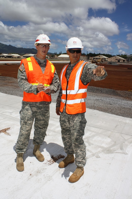 Cadet Walker Glunz (left) takes notes about the Combat Aviation Brigade Phase 1 infrastructure project site layout from Schofield Barracks Area Office Deputy Area Engineer Capt. Alberto Baez. 