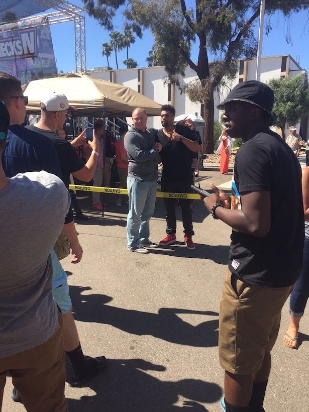 Deray Davis, comedian, takes pictures with a fan aboard Marine Corps Air Station Miramar, California, August 8. Davis was one of the opening acts for Lupe Fiasco. (U.S. Marine Corps photo by Lance Cpl. Kimberlyn Adams/Released)