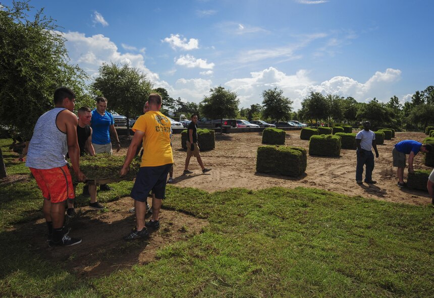 Airmen move a pallet of sod at Soundside Lodging on Hurlburt Field, Fla., Aug. 6, 2015. Approximately 30 Airmen from Hurlburt laid 19,800 square feet of sod at Soundside Lodging as part of Pride Epidemic. (U.S. Air Force photo by Senior Airman Meagan Schutter)