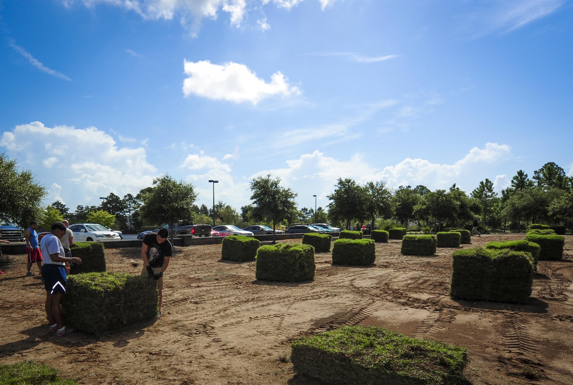 Volunteers prepare to lay sod at Soundside Lodging on Hurlburt Field, Fla., Aug. 6, 2015. Approximately 30 Airmen from Hurlburt laid 19,800 square feet of sod at Soundside Lodging as part of Pride Epidemic. (U.S. Air Force photo by Senior Airman Meagan Schutter)