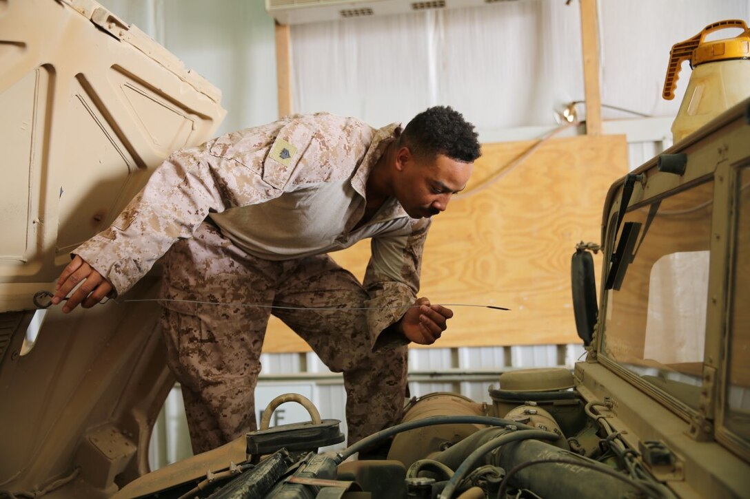 U.S. Marine Sgt. Fox Walkeithus, a motor transport mechanic with the Special Purpose Marine Air – Ground Task Force – Crisis Response – Central Command, checks the oil of a Humvee at Al Asad Air Base, Iraq, July 30, 2015. Walkeithus and a team of six other Marines spent a week conducting preventive maintenance checks for Task Force Al Asad’s vehicles and equipment. Task Force Al Asad is a multinational coalition participating in Combined Joint Task Force – Operation Inherent Resolve’s building partner capacity mission, which trains and enables Iraqi security forces in their fight against the Islamic State of Iraq and the Levant. (U.S. Marine Corps photo by Cpl. Garrett White/Released)
