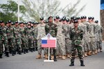 PORT DICKSON, Malaysia (Aug. 11, 2015) - Armed forces members of the U.S. and Malaysia stand in formation during the Exercise Keris Aman 2015 opening ceremony held at the Segenting Camp's Army Academy Parade Ground in Port Dickson.  Keris Aman is a multinational training event co-hosted by the Malaysian Armed Forces and U.S. Pacific Command with representatives from 29 nations participating. Training events and exercises such as Keris Aman contribute to regional peacekeeping training capacity and strengthen multinational cooperation in global missions. 