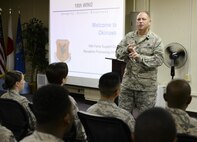 U.S. Air Force Lt. Col. Kieran Keelty, 18th Mission Support Group deputy commander, briefs approximately 50 Airmen at the reception processing unit during a Mission Focused Exercise on Kadena Air Base, Japan, Aug. 5, 2015. The exercise, known as Beverly High 15-3, is the third MFE conducted at Kadena Air Base for Fiscal Year 2015. It is designed to simulate contingency operations taken from one or more of the wing's mission sets such as forward power projection with the purpose of polishing procedures and demonstrating capabilities. (U.S. Air Force photo by Airman 1st Class John Linzmeier)