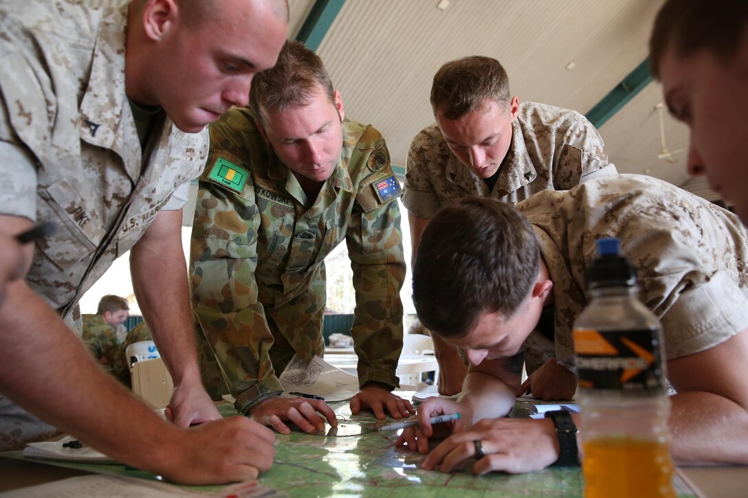 U.S. Marine Corps Lance Cpls. Eric Moore, Zach Hamlin, and Benjamin Pike, riflemen with Company A, 1st Battalion, 4th Marine Regiment, Marine Rotational Force – Darwin, and PTE Craig Rutkowski, a rifleman with Delta Company, 5th Battalion, The Royal Australian Regiment, 1st Brigade, Australian Army, Australian Defence Force, discuss where to plot points on a map during an operations order class Aug. 5 at Robertson Barracks, Palmerston, Northern Territory, Australia. The course was overseen by 5 RAR leaders and staff noncommissioned officers with MRF-D. The course was an excellent opportunity to improve Marines’ knowledge of the ADF military training, which ultimately strengthens our interoperability.