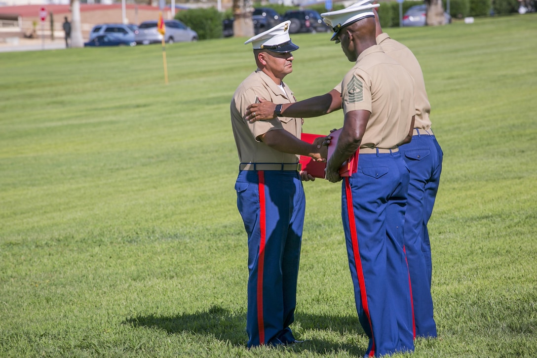During his retirement ceremony, 1st Sgt. Nelson A. Hidalgo, Company A First Sergeant, 1st Tank Battalion, receives the Meritorious Service Medal at Lance Cpl. Torrey L. Gray Field, Aug. 7, 2015. Hidalgo began his service in the Marine Corps as a basic rifleman with 2nd Battalion, 8th Marine Regiment, in 1995. (Official Marine Corps photo by Pfc. Levi Schultz/Released)