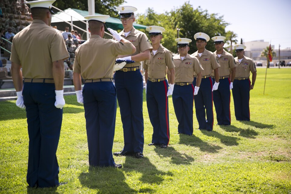 Marines with 1st Tank Battalion perform the passing of the colors presentation during the reciting of “Old Glory” during a retirement ceremony for 1st Sgt. Nelson A. Hidalgo, Company A First Sergeant, 1st Tanks, at Lance Cpl. Torrey L. Gray Field, Aug. 7, 2015. During the presentation, the flag was passed between Marines of every rank Hidalgo has held throughout his career. (Official Marine Corps photo by Pfc. Levi Schultz/Released)