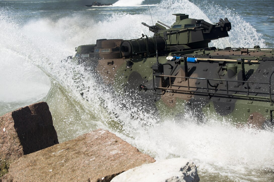 Marines with Company C., 4th Assault Amphibian Battalion, 4th Marine Division, Marine Forces Reserve, drive an amphibious assault vehicle from land into the water during a basic operations exercise at the Galveston Marine Corps Reserve Home Training Center, Galveston, Texas, Aug. 8, 2015. The exercise served as a refresher for the Marines on how to perform basic AAV operations. During the exercise, the Marines drove the AAVs from land to water and performed basic water operations such as left and right turns, forward and reverse, circles and tactic formations.