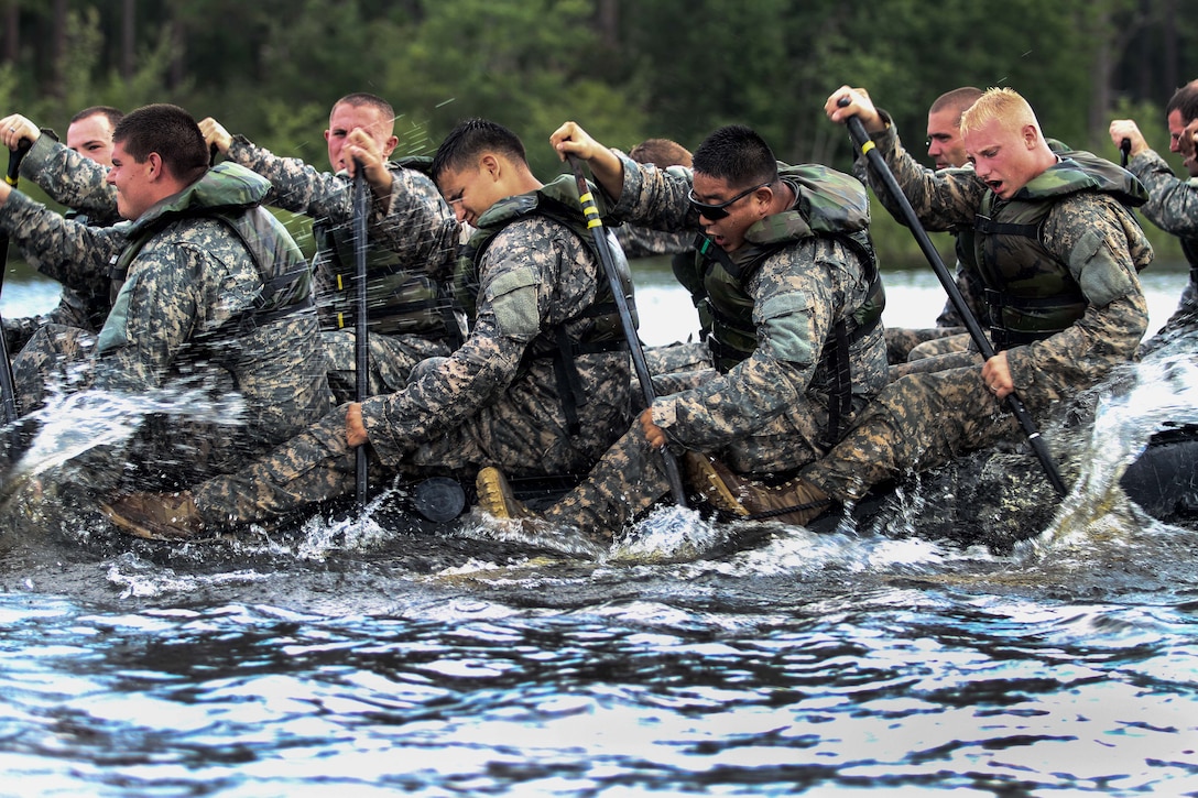 Paratroopers paddle a Zodiac boat across Mott Lake on Fort Bragg, N.C