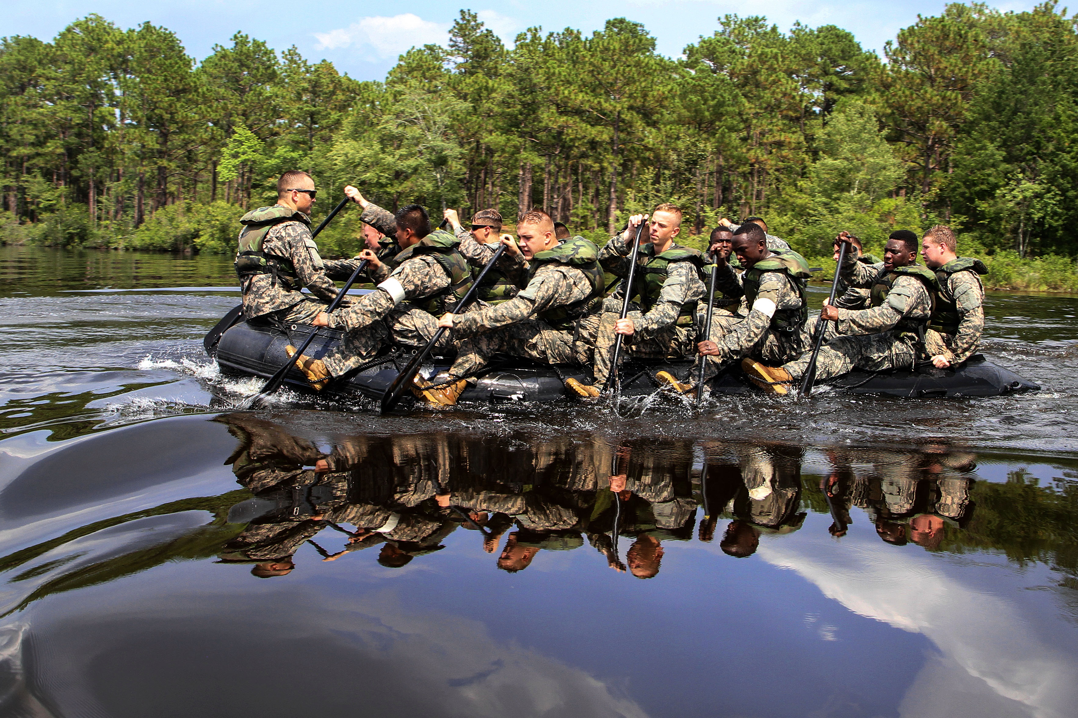 Paratroopers paddle a Zodiac boat across Mott Lake on Fort Bragg, N.C