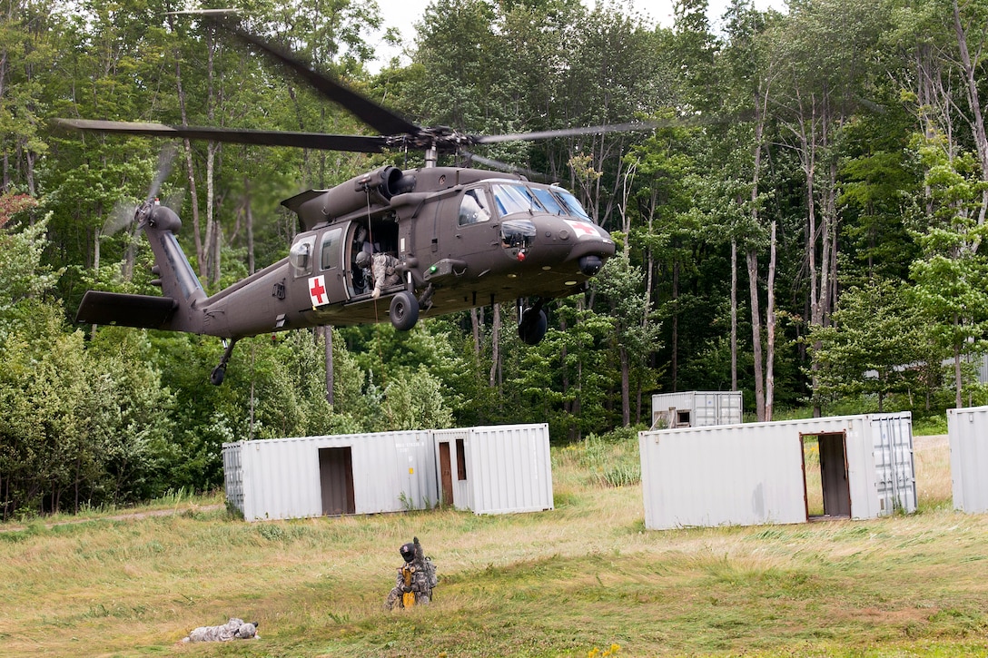 A Vermont Army National Guardsman rides a jungle penetrator into a UH-60 Black Hawk helicopter during medical evacuation training at Camp Ethan Allen Training Site, Jericho, Vt., Aug. 1, 2015.
