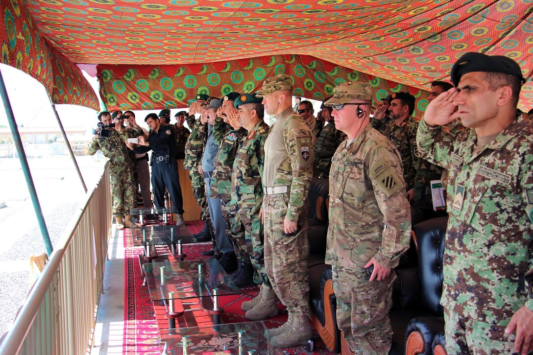 From right, Afghan army Command Sgt. Maj. Roshan Safi, the sergeant major of the Afghan army; U.S. Army Brig. Gen. Christopher Bentley, commander of Train Advise Assist Command-East; U.S. Army Maj. Gen. Jeffrey Buchanan, the Resolute Support deputy chief of staff for operations; Afghan army Lt. Gen. Qadim Shah, the Afghan army chief of general staff; and Afghan army Maj. Gen. Mohammad Zaman Waziri, commander of the 201st Corps, render honors as the Afghan national anthem plays during a visit from senior Afghan and U.S. military personnel to the Regional Military Training Center at Tactical Base Gamberi in Laghman province, Afghanistan, July 30, 2015.