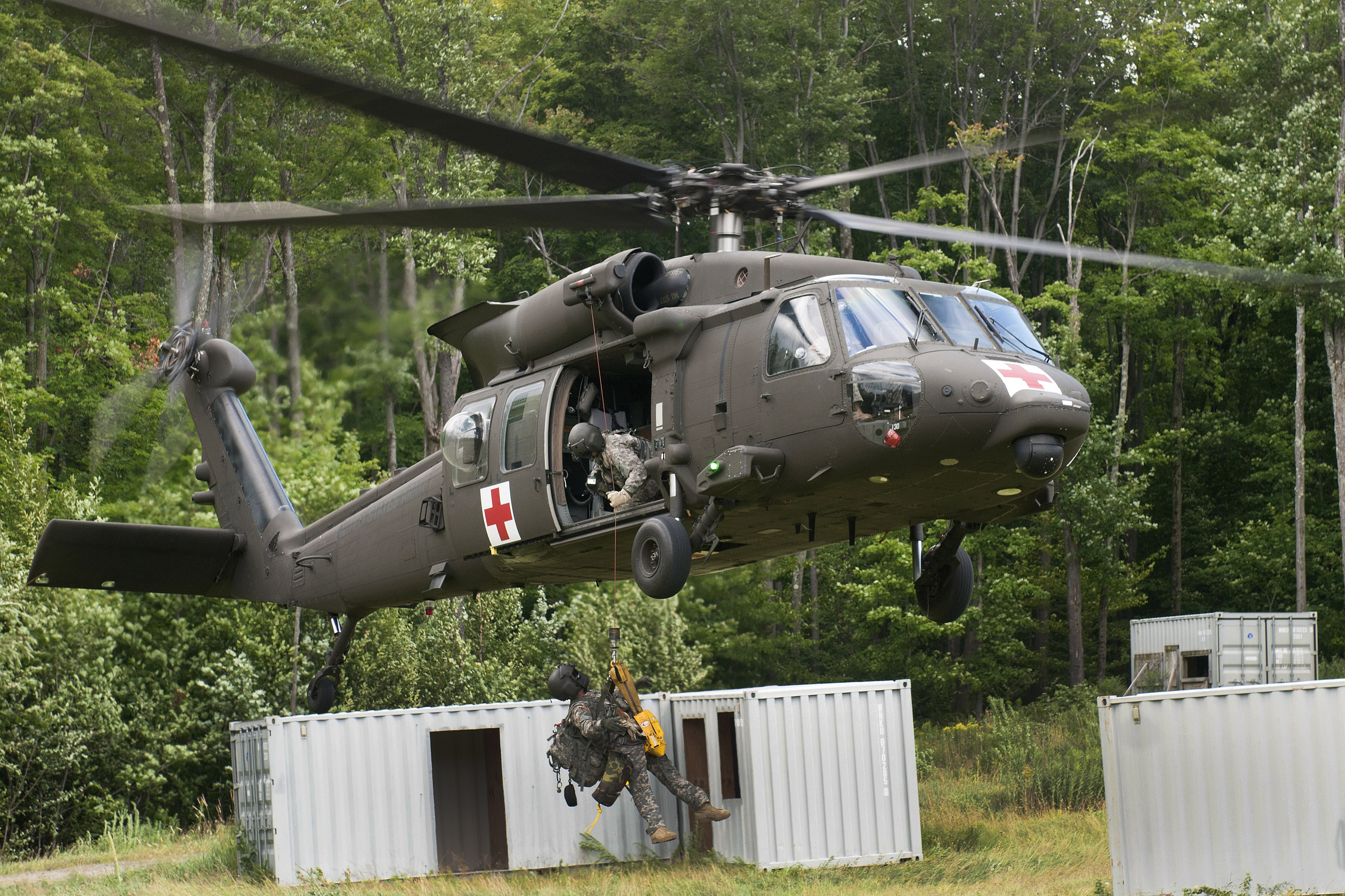 A Vermont Army National Guardsman is hoisted up on a jungle