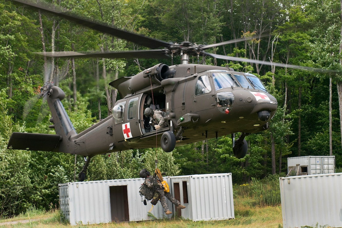 A Vermont Army National Guardsman is hoisted up on a jungle