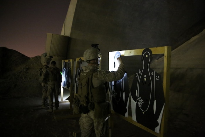 U.S. Marines with Headquarters Company, 3rd Battalion, 7th Marine Regiment, Special Purpose Marine Air-Ground Task Force-Crisis Response-Central Command, observe their shot groups during a night range in Southwest Asia, Aug. 8, 2015. These Marines provide security at one of the SPMAGTF operating bases in the Middle East. The Marines and Sailors of SPMAGTF-CR-CC offer rapid, task-organized solutions to the commander of USCENTCOM across an area of operations spanning 20 countries.