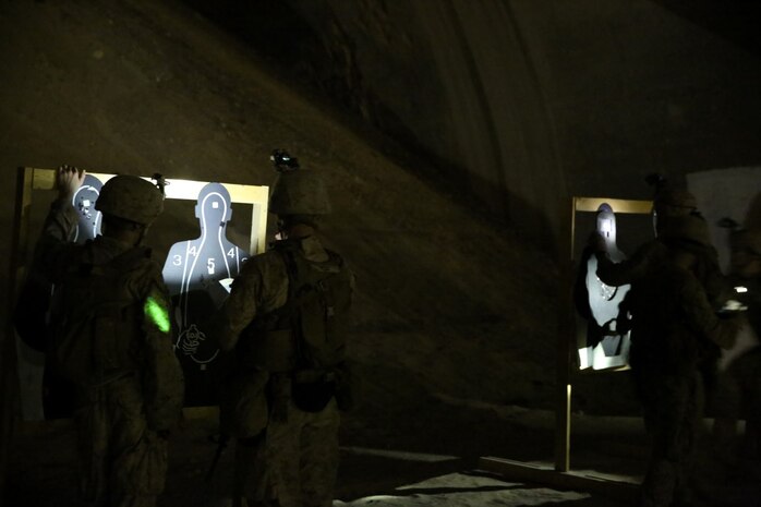 U.S. Marines with Headquarters Company, 3rd Battalion, 7th Marine Regiment, Special Purpose Marine Air-Ground Task Force-Crisis Response-Central Command, observe their shot groups during a night range in Southwest Asia, Aug. 8, 2015. These Marines provide security at one of the SPMAGTF operating bases in the Middle East. The Marines and Sailors of SPMAGTF-CR-CC offer rapid, task-organized solutions to the commander of USCENTCOM across an area of operations spanning 20 countries.